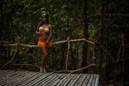 Woman posing on wooden floor background in forestの写真素材