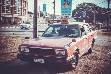 Retro car parked in old city street in Malaysia.のeditorial素材