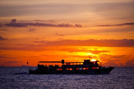 Amazing sunset over the beautiful sky with clouds, rippling waters of the sea and sailing ships. Koh Samui Thailandの写真素材