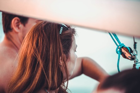 romantic couple in love on a pleasure yacht relaxing at sunset timeの写真素材