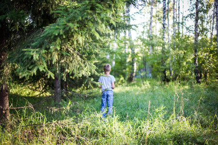 Young guy  standing in a forestの写真素材