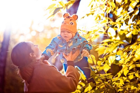 A happy family in a park on a sunny autumn dayの写真素材