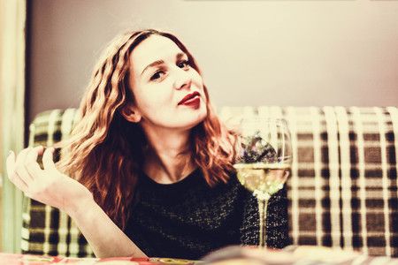 A smiling woman in a restaurant with the menu in handsの写真素材