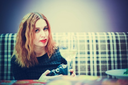 Woman with camera take a photo at cafeの写真素材