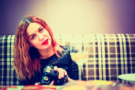 Woman with camera take a photo at cafe