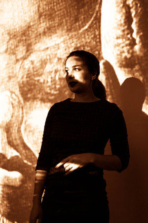 Dramatic portrait of a girl theme: portrait of a beautiful lonely girl on a dark background in studioの写真素材