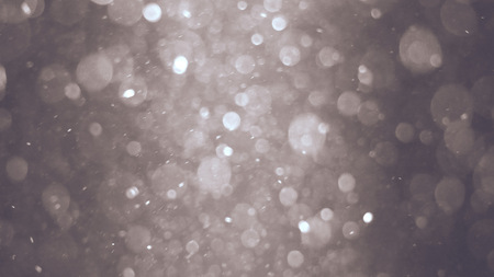 Abstract silver background with beautiful shine flickering particles. Underwater bubbles in flow with bokehの写真素材