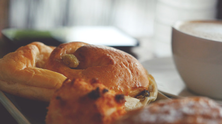 Cappuccino with a French roll for breakfastの写真素材