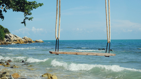 Tropical Island Beach and Tree Swing. Splashing waves in the Sea. Paradise at Koh Samuiの写真素材