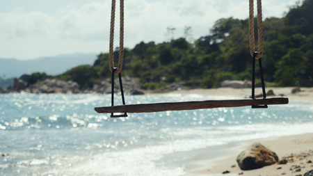 Tropical Island Beach and Tree Swing. Splashing waves in the Sea at stones on beautiful background. Paradise at Koh Samuiの写真素材