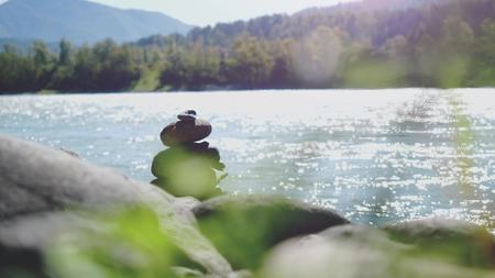 Balance stone on river coast in nature landscape on Altai republicの写真素材