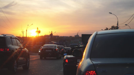 Russia, Novosibirsk, 17 september 2017. Car traffic and beauiful sunset on the road