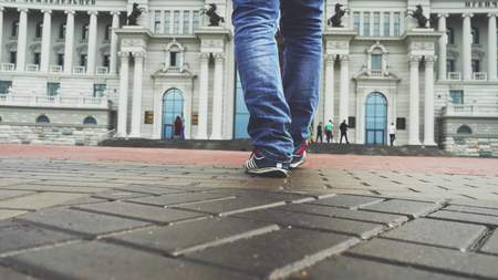 Businessmen feet walks down a city side walkの写真素材
