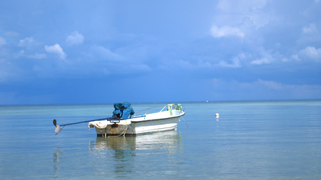 Tropical Paradise at Koh Phangan. Sail boat in Lazure turquoise sea in cloudy day on beautiful sky on the background.の写真素材