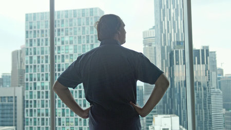 Young successful rich man admire the city center with skyscrapers view