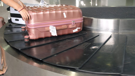 Airport baggage claim with luggage spinning around conveyor