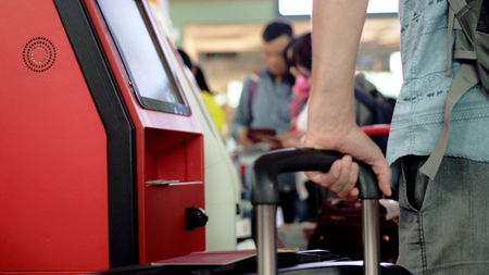 Check-in at self help desk in the airport. Close up of suitcaseの写真素材
