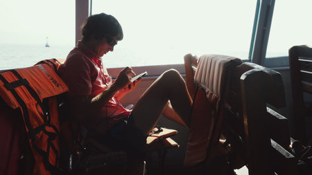 Young attractive man in sunglasses with headphones and mobile phone listen to music while traveling...