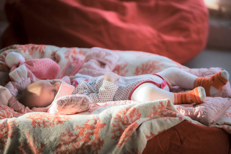 Portrait of sleeping cute baby in homeの写真素材