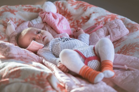 Cute little baby laying on back on the soft coverの写真素材