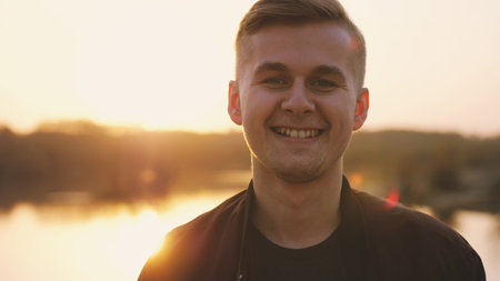 Young happy handsome man enjoying sunlight