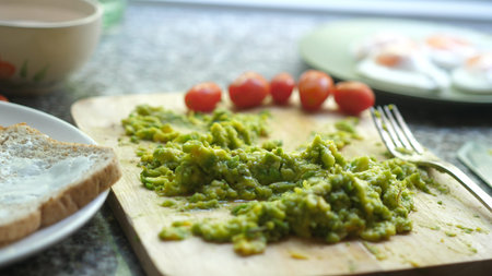 Close up of mashed avocado on a wooden board for guacamole ar bruschettaの写真素材