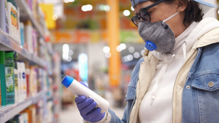 Old woman aged wearing medical Mask and gloves during coronavirus Shopping Hygiene Products At...