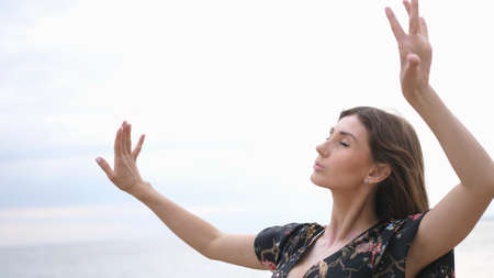 Young beautiful woman dancing on the seashoreの写真素材