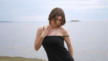 Young beautiful woman dancing on the seashoreの写真素材