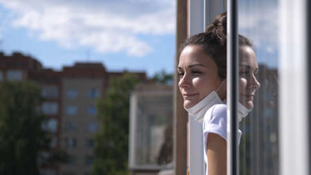 Pretty girl in the removed mask on the balcony.の写真素材