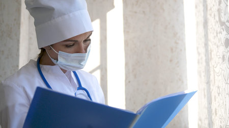 Female Doctor standing with folder