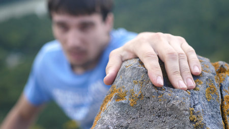 Mountain Climber Man Reaching The Top Doing His Best.