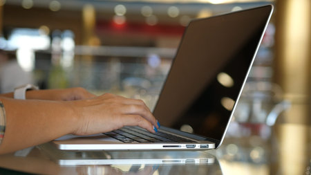 Woman working with laptop on Desktop. Woman Blogger Freelancer Working on Laptop at Cafe