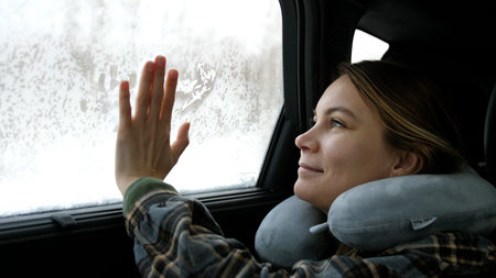 Girl woman hand touch on frozen window at winter