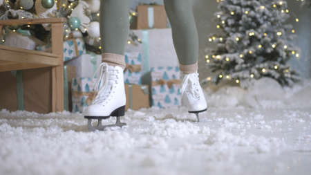 Happy young woman skates on ice rinkの写真素材