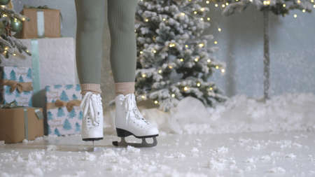 Happy young woman skates on ice rinkの写真素材