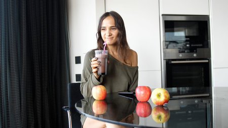 Young Attractive Woman Drinking Fresh fruit Smoothie Shake Juice Using Strawの写真素材