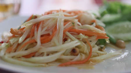 Close up of fresh yummy delicious Thai traditional popular street food spicy green papaya salad or Som Tam in dishの写真素材