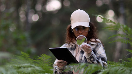 Female scientist biologist researcher testing seedling plant test tube lab using digital tablet, Innovative agricultural technologies smart organic farm futureの写真素材