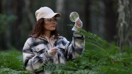 Female scientist biologist researcher testing seedling plant test tube lab. Biological agriculture research genetic engineering laboratoryの写真素材