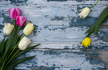 Bouquet of tulips on wooden background. Top view.