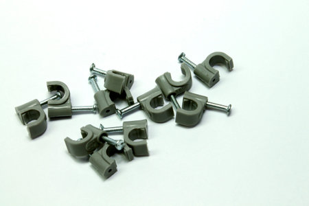 grey clips for fixing cables with nailの写真素材