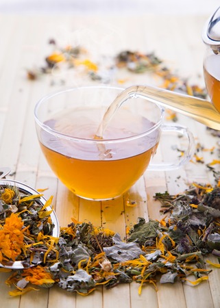 Hot cup of handmade tea from calendula and other herbsの写真素材