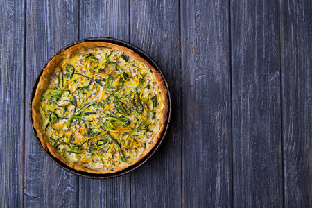 Homemade baked zucchini quiche lorraine with eggs, milk and cumin in rustic styleの写真素材