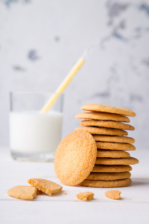 Tower from shortbread kamut cookies with glass of milk and strawの写真素材