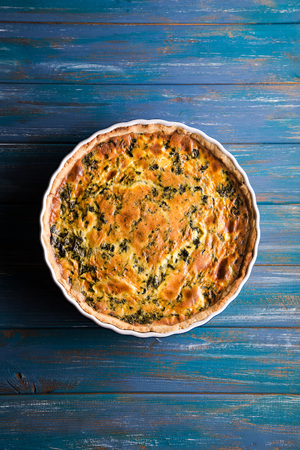 Homemade spinach french pie quiche lorraine on wooden boardの写真素材