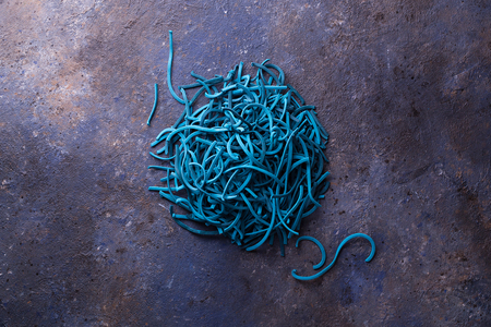 Blue Colored Pasta on Dark Background Center. Flat Lay. Copy space. Top view.の写真素材
