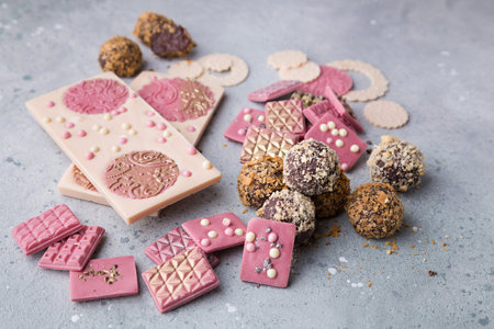 Ruby and white chocolate bar with chocolate truffle candies with gold, silver and crisp
