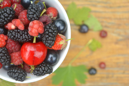 Fresh organic summer berries in a cup. Currant, raspberry, mulberry