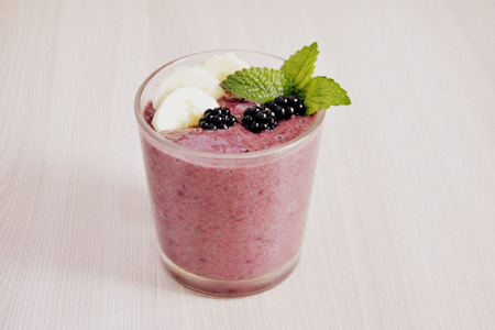 Banana and blackberry smoothie on the tableの写真素材